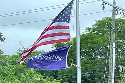 The American flag and the Purple Flag for Dementia Care flag.